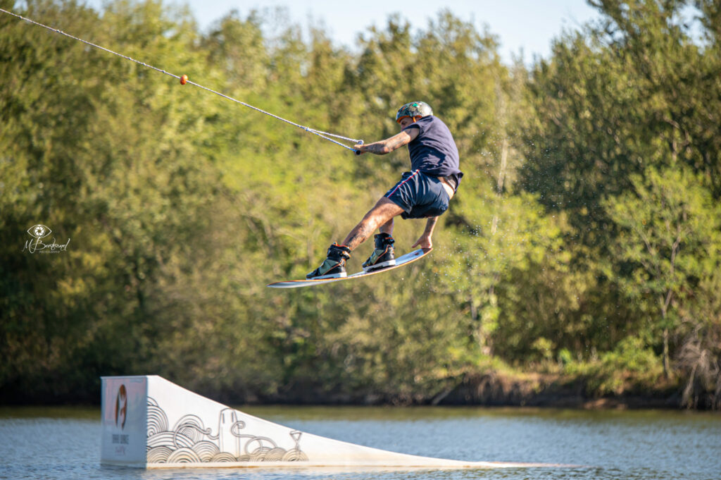 Tail grab in wakeboard on a trampoline